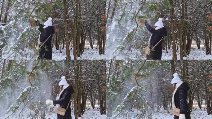 开朗的年轻女子在冬季公园里抖雪，在雪下玩耍