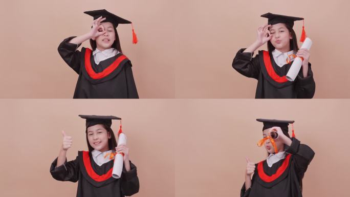 一个穿着毕业礼服的女学生在棕色背景上做着快乐的手势和表情。