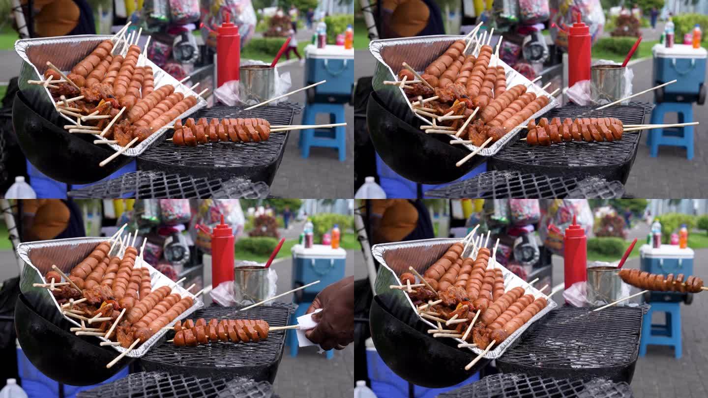 在巴拿马卖街头小吃:挑选烤肉串(香肠和腌肉)，用一瓶瓶的烧烤酱。慢镜头。