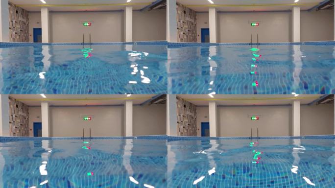 用于游泳和训练的室内游泳池。教孩子游泳。蓝色透明的水，背景。文字的复制空间，没有人
