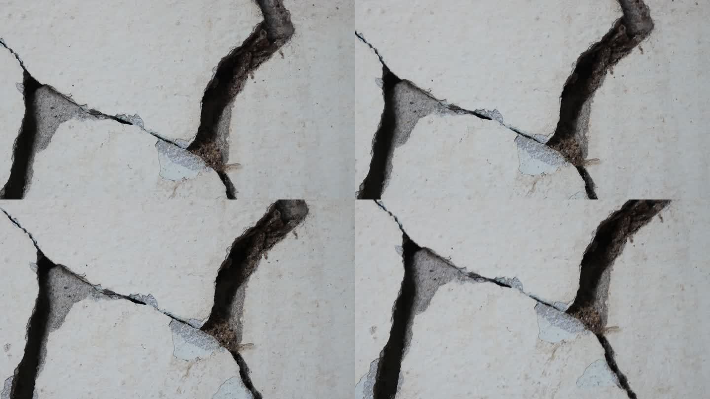 旧混凝土墙背景有大裂缝。灰水泥墙面破损大。
