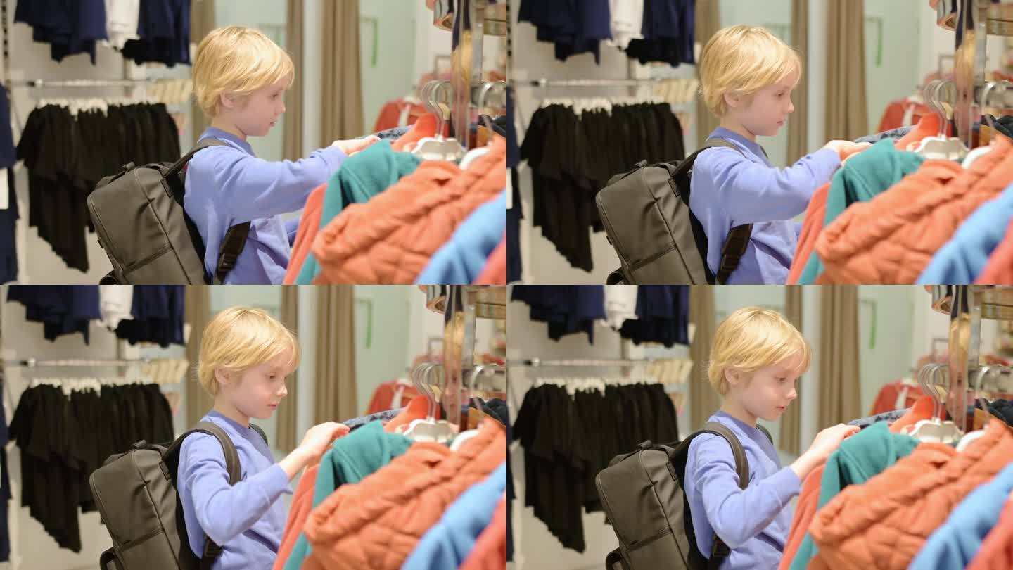 一个漂亮的十几岁前的男孩在商店里为自己挑选时尚的应季保暖衣服。为有孩子的家庭购物。