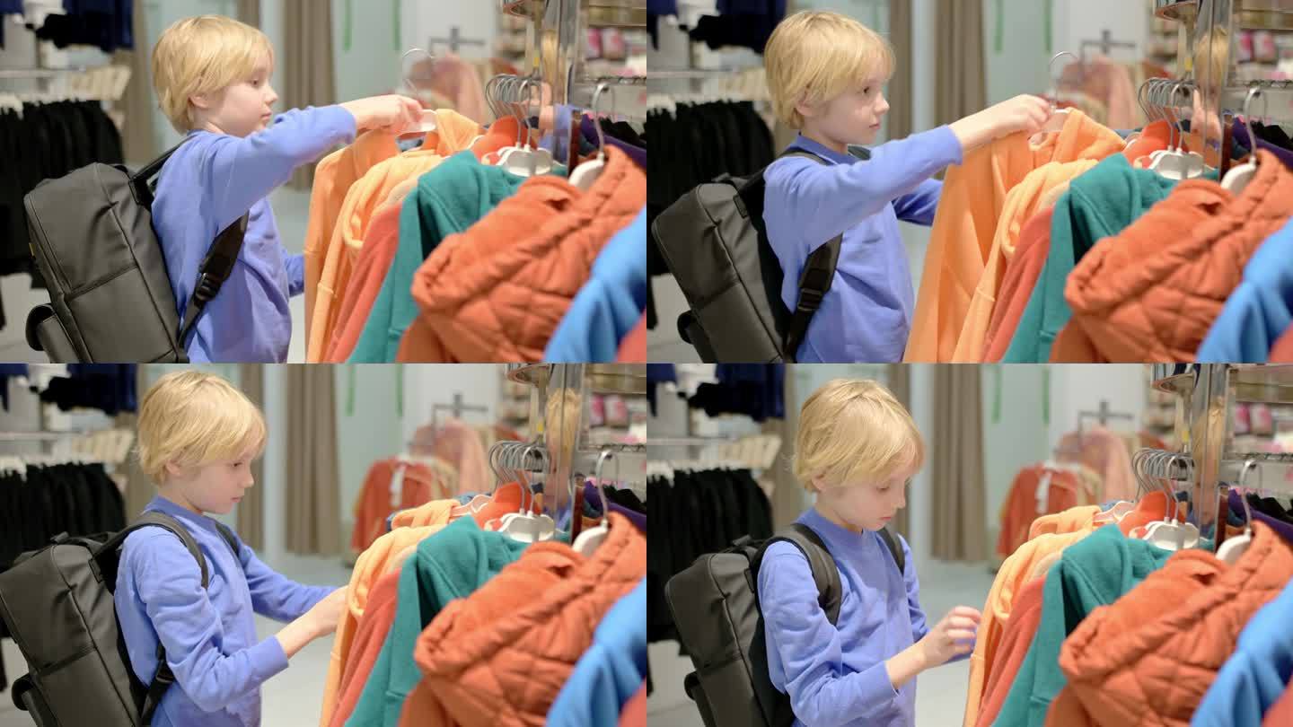 一个漂亮的十几岁前的男孩在商店里为自己挑选时尚的应季保暖衣服。为有孩子的家庭购物。