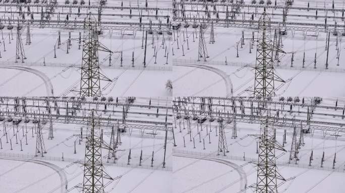 高压电塔以雪景变电站为背景，无人机载重盘