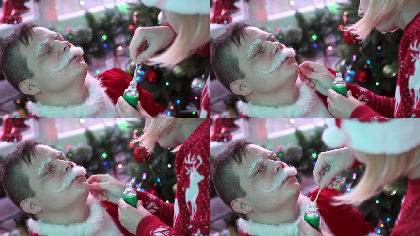 圣诞派对前，化妆师在脸上涂上胡须胶。