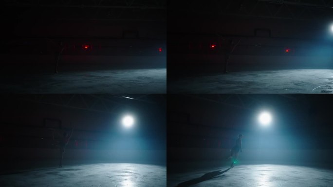 黑暗中在冰上跳舞的优雅女人的剪影，慢镜头，花样滑冰