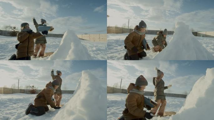 两个孩子保护雪堡，并向敌人队扔雪球