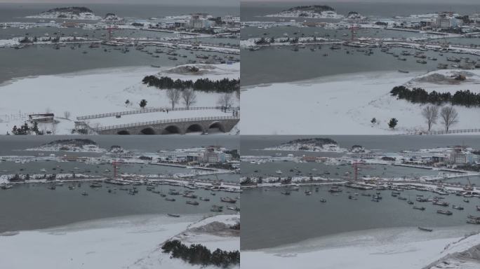 航拍威海小石岛桥渔港海湾冬季雪后海岸风光