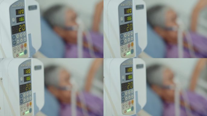 医院里病人的生理盐水静脉滴注和输液泵，特写