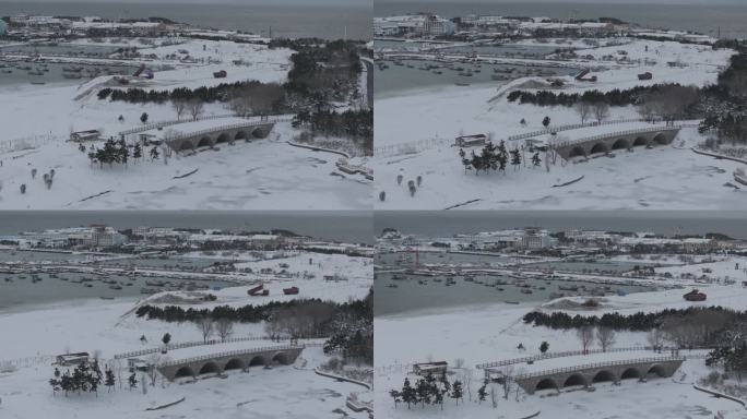 航拍威海小石岛桥渔港海湾冬季雪后海岸风光