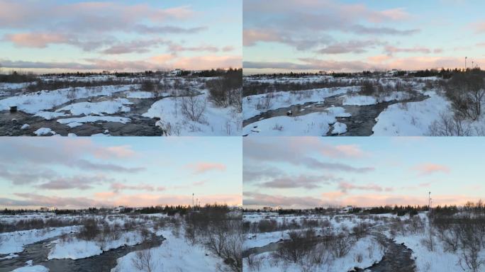 冰岛的冬天。从空中俯瞰河流。雷克雅未克的日出。白雪覆盖的城市，阳光明媚的早晨。