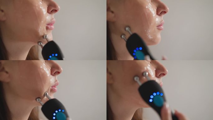 女人用微电流装置按摩皮肤的问题区域