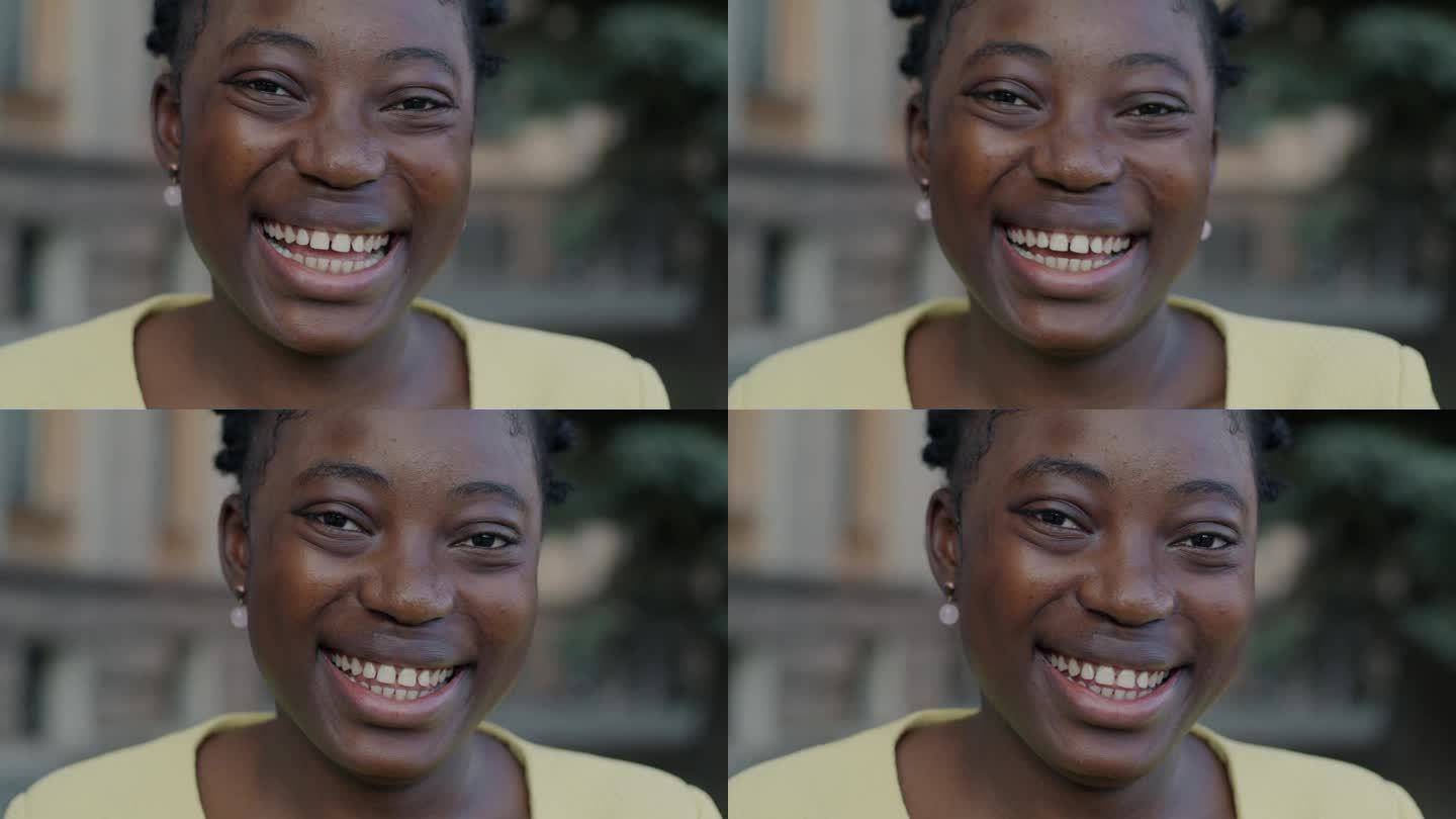 快乐的非裔美国妇女在城市户外笑着表达幸福的特写肖像