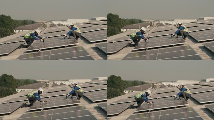 绿色科技中的团队合作:工程师在屋顶上检查光伏太阳能板。