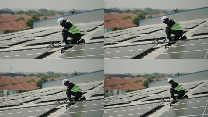 可持续能源:身穿制服的非洲工程师为屋顶太阳能电池板进行可靠的能源检查。
