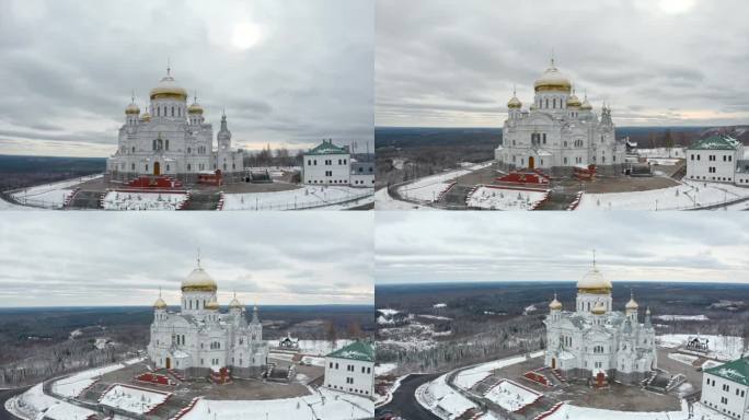 在寒冷的冬日，鸟瞰一座金色圆顶的白色教堂。夹。宗教和建筑的概念。