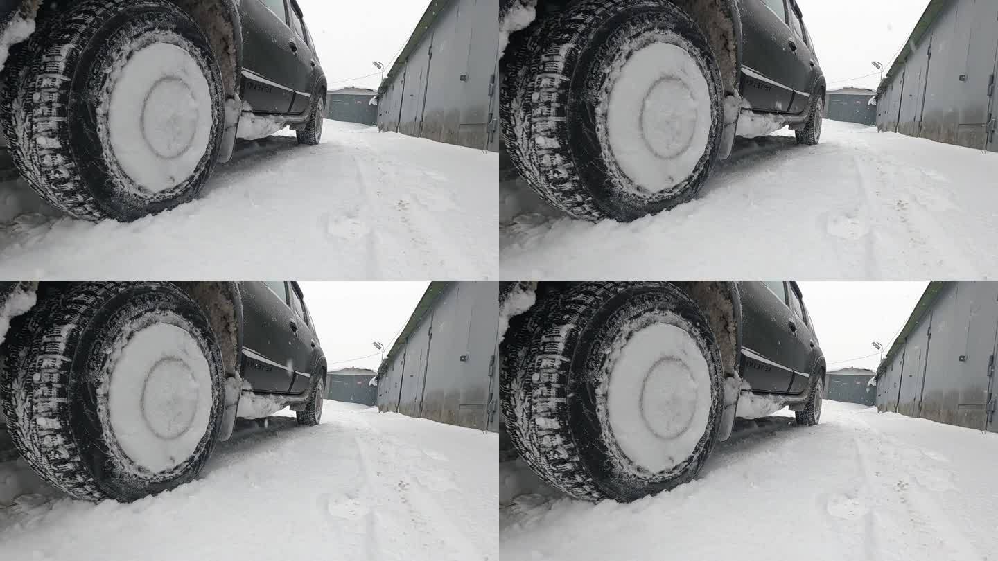 装有冬季铆钉轮胎的前轮在镜头前急刹车。缓慢的运动。
