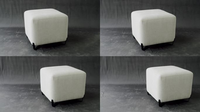舒适的白色面料靠垫。优雅的方形泡芙。舒适的座椅与现代的软垫。