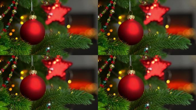 壁炉背景下圣诞树上的红球特写。新的一年