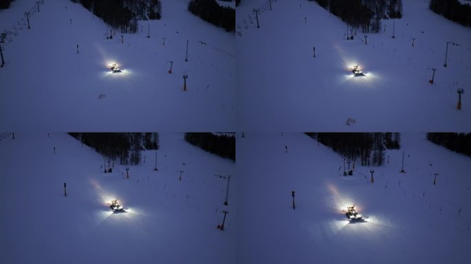 在斯洛文尼亚克拉尼斯卡戈拉的冬夜，在积雪的高山滑雪坡上工作的雪车鸟瞰图。无人机俯瞰雪车梳理雪，滑雪胜