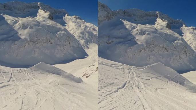 滑雪者享受假期的镜头。男子正在雪山上玩单板滑雪。他在探索大自然。