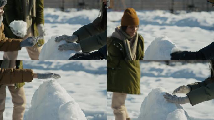 孩子们的手在院子里建造雪堡