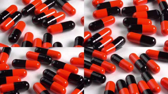 许多黑色和橙色药丸胶囊或抗抑郁药在宏观侧面的白色盘子上旋转。止痛头痛的药物或药物。制药行业