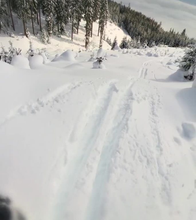 滑雪者在山上的POV镜头。一名男子在雪景上练习滑雪特技。他正在享受假期。