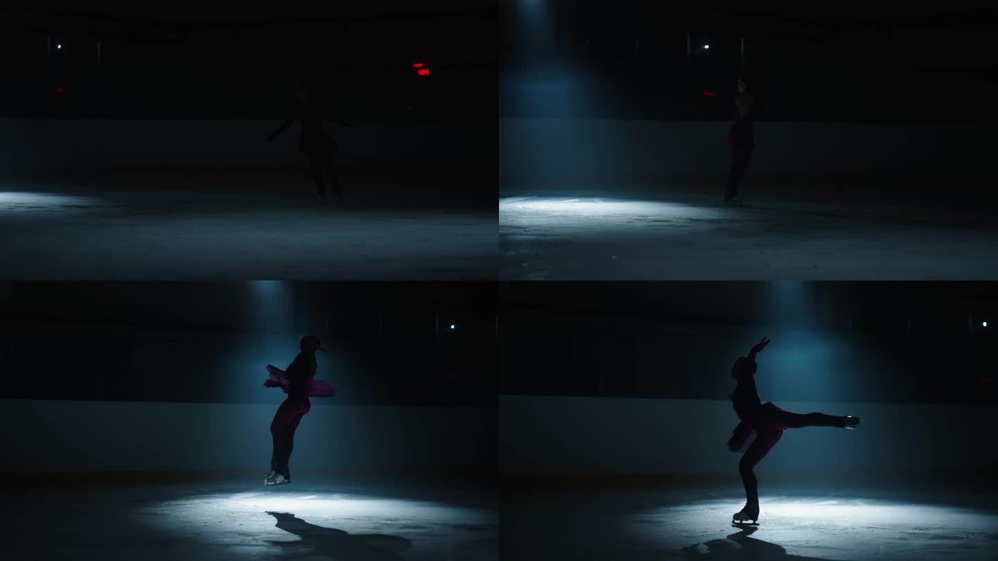 冰上表演，黑暗中冰上优雅女子花样滑冰运动员的剪影，训练女孩
