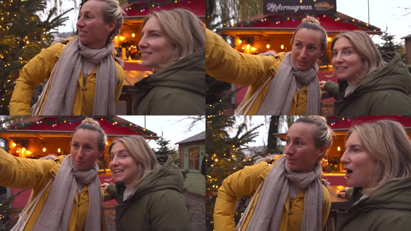两个女性朋友一起享受冬季市场