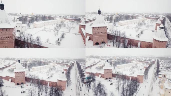 在冬天的雪天里飞过红塔砖栅栏的古堡垒。