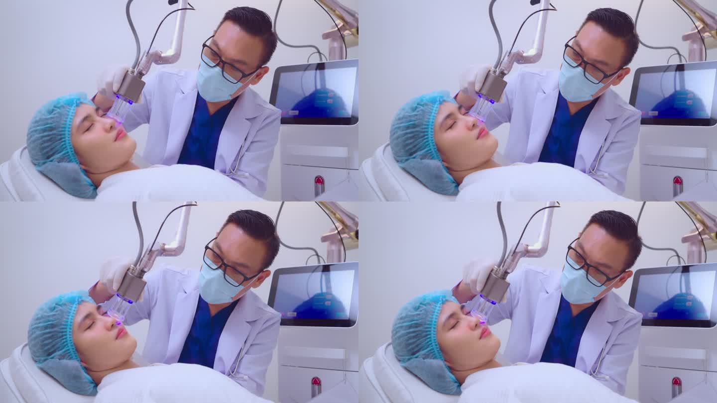 医生在美容诊所用激光照射女人的脸。