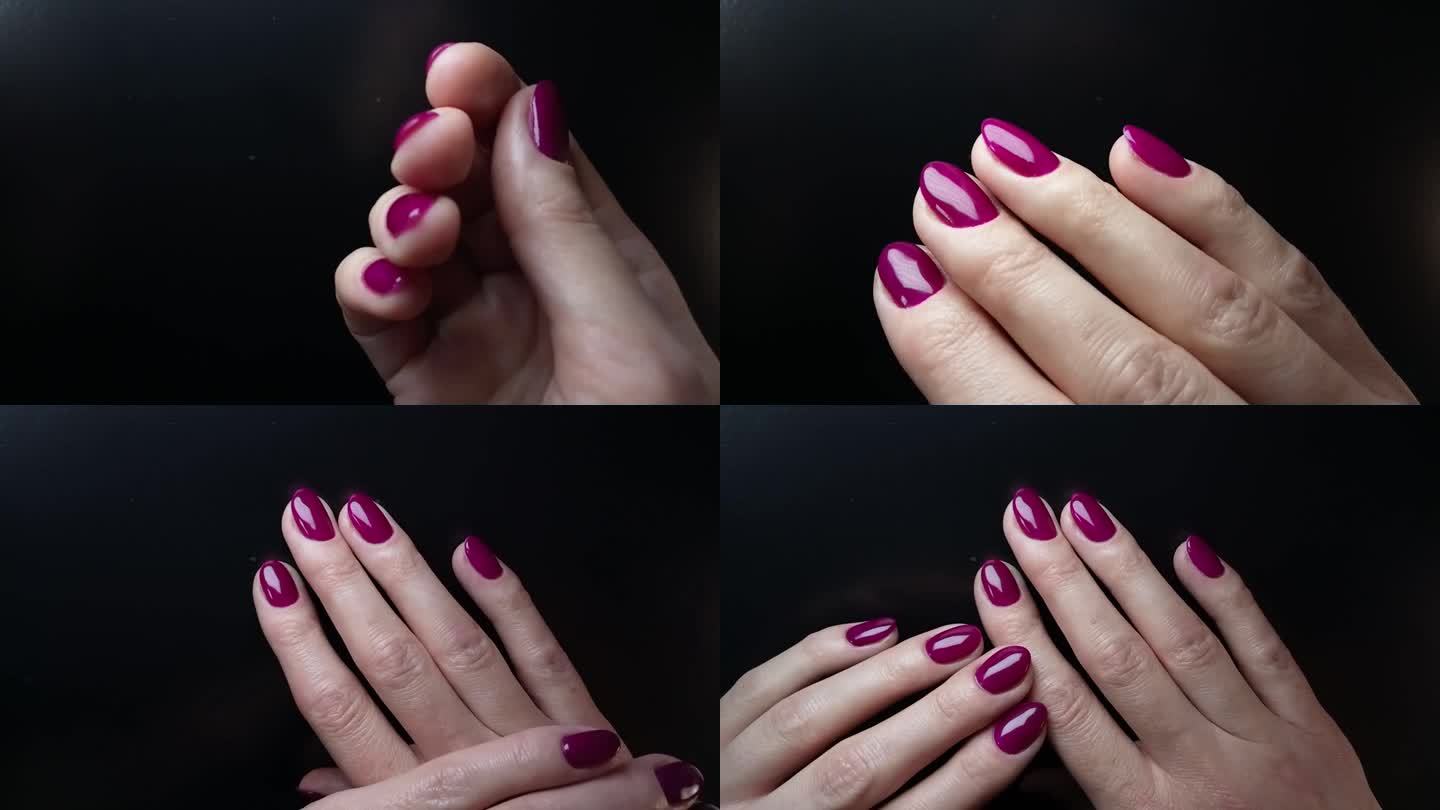 一位女士展示用亮紫色指甲油涂的指甲