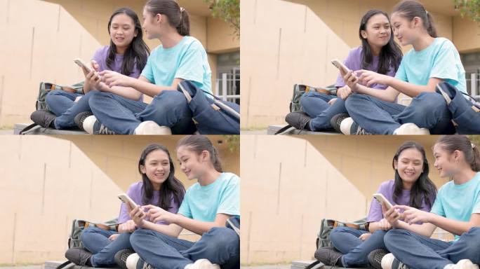 快乐的亚洲女生在学校使用智能手机