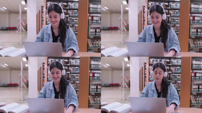 一名亚洲女学生在大学图书馆用笔记本电脑视频讲解课程内容。展示对虚拟学习的适应性。