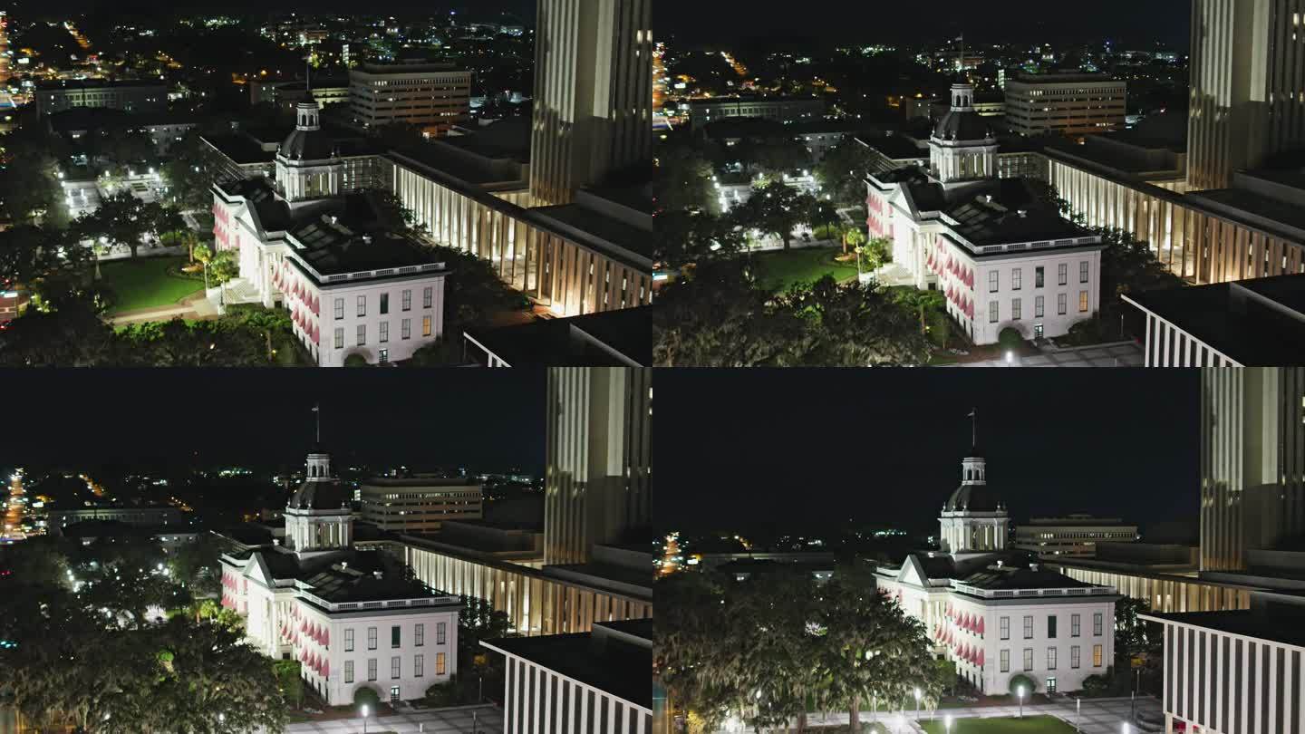 佛罗里达州塔拉哈西市中心的夜景。州议会大厦坐落在商业区的中心。航拍镜头与下降倾斜摄影机运动。