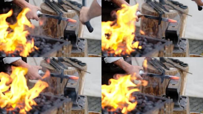 两个强壮的铁匠在铁砧上锻造钢铁。前景火焰与燃烧的钢铁材料。手工工艺品工业4K素材。