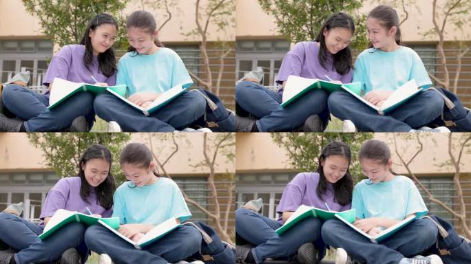 快乐的亚洲女生在学校里学习和讨论家庭作业