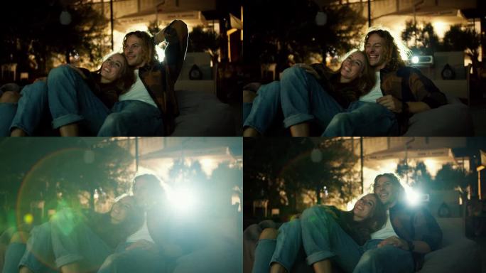 特写:一对相爱的情侣躺在豆袋椅上看电影。周末休息