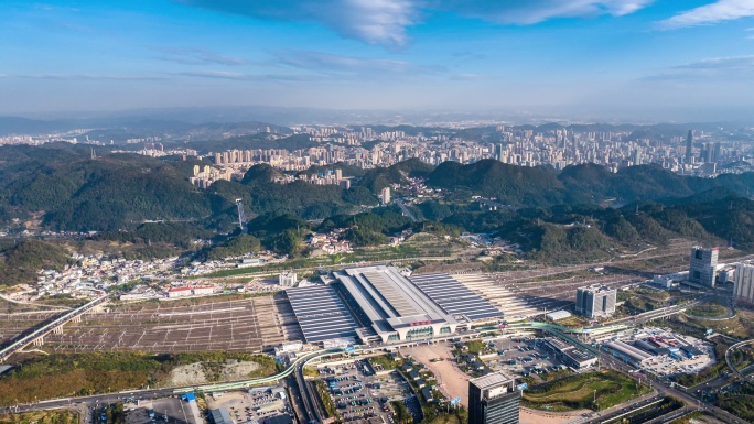 贵州贵阳北站蓝天白云航拍城市建筑与群山