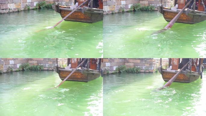 江南水乡乌镇乌篷船划过波光粼粼的水面