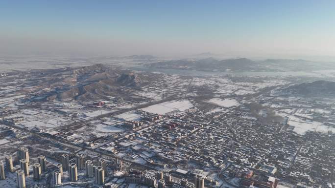 航拍北方雪后山峰湖农村