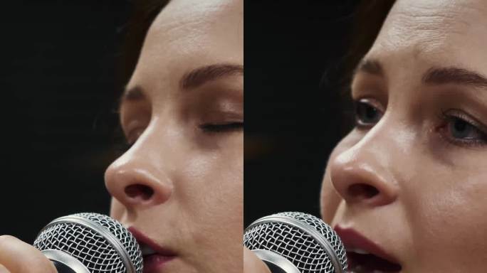 女歌手的脸和黑色背景的麦克风。垂直视频
