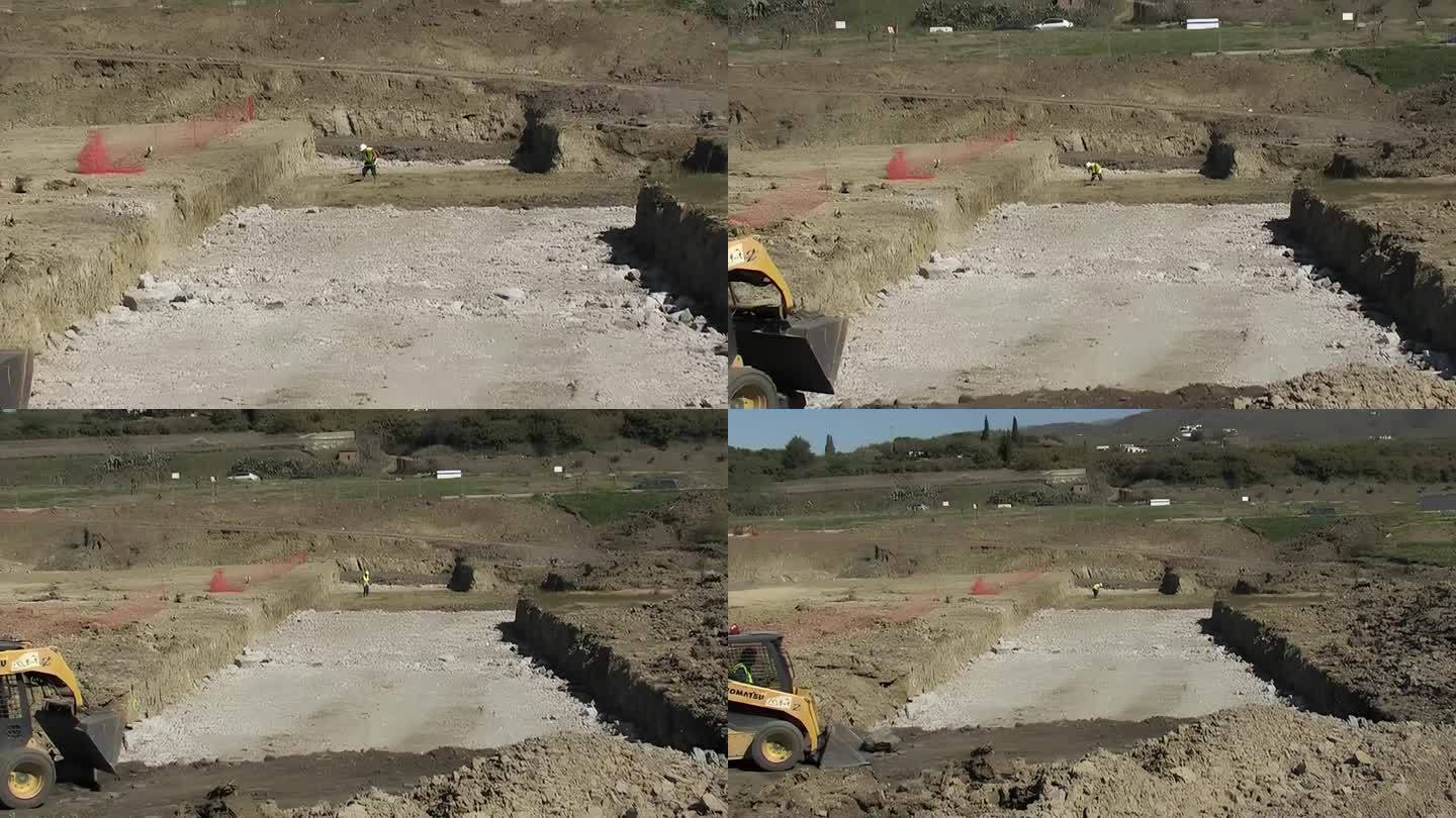 操作人员用铲车和滑舵装载机平整土壤，镜头缩小