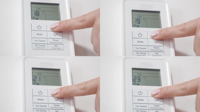 摄像头聚焦在白色墙上的空调遥控器上，女子打开空调，将温度调到最高。