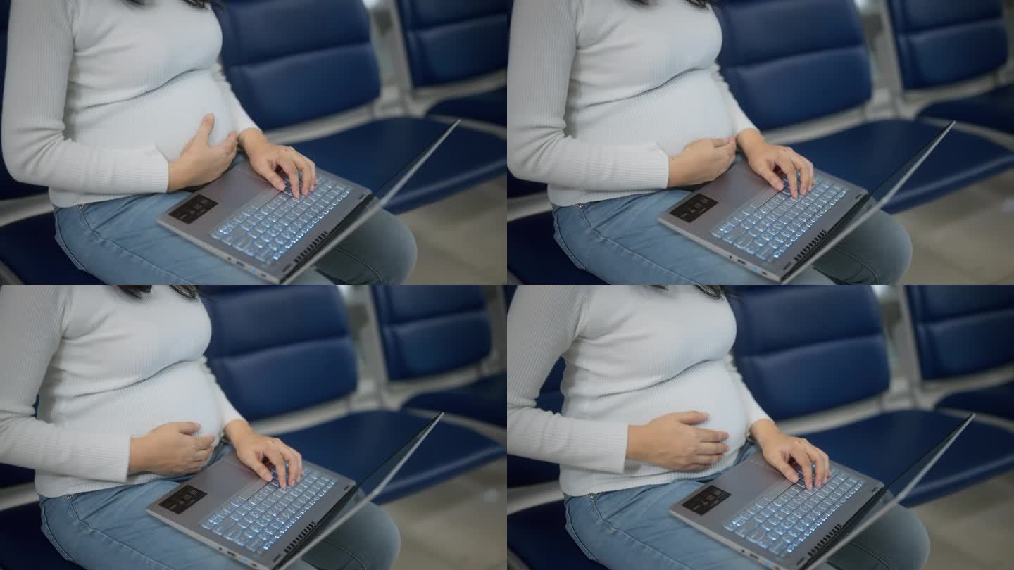 商务女性度假时在机场候机时使用笔记本电脑