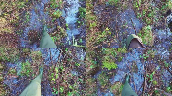 一个穿着橡胶长靴的人走在沼泽地里，POV慢镜头