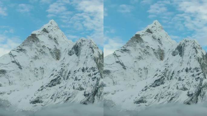 一名男子在楠格曾峰上望着阿玛达布拉姆山。尼泊尔的喜马拉雅山脉。鸟瞰图。垂直视频