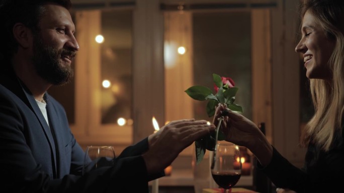 约会，情人节，第一次约会。不管是在餐厅还是在家里，浪漫的烛光晚餐上，男人都会送给女人一朵玫瑰