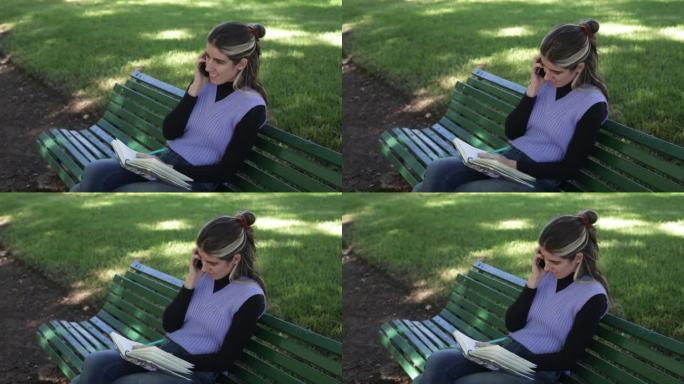年轻女子在公园边做笔记边讲手机
